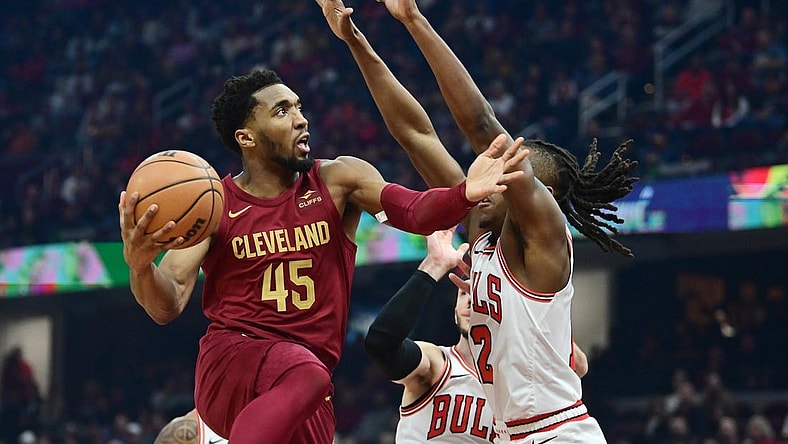 Feb 14, 2024; Cleveland, Ohio, USA; Cleveland Cavaliers guard Donovan Mitchell (45) drives to the basket against Chicago Bulls guard Ayo Dosunmu (12) during the first half at Rocket Mortgage FieldHouse. Mandatory Credit: Ken Blaze-USA TODAY Sports