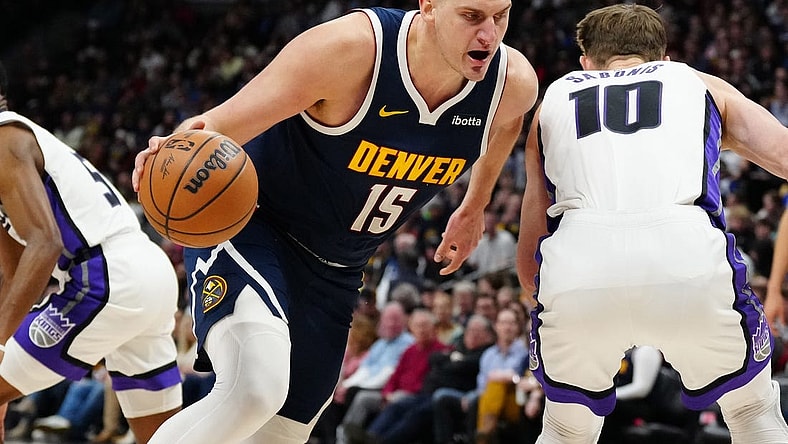 Feb 14, 2024; Denver, Colorado, USA; Denver Nuggets center Nikola Jokic (15) drives around Sacramento Kings forward Domantas Sabonis (10) in the first quarter at Ball Arena. Mandatory Credit: Ron Chenoy-USA TODAY Sports