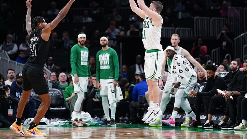 Feb 14, 2024; Boston, Massachusetts, USA; Boston Celtics guard Payton Pritchard (11) shoots for three points against Brooklyn Nets forward Noah Clowney (21) in the second half at TD Garden. Mandatory Credit: David Butler II-USA TODAY Sports