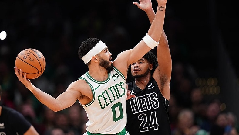Feb 14, 2024; Boston, Massachusetts, USA; Boston Celtics forward Jayson Tatum (0) looks for an opening against Brooklyn Nets guard Cam Thomas (24) in the second half at TD Garden. Mandatory Credit: David Butler II-USA TODAY Sports