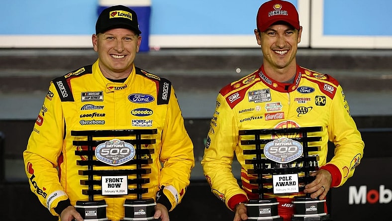 Feb 14, 2024; Daytona Beach, Florida, USA; NASCAR Cup Series driver Joey Logano (right) poses with the pole award with driver Michael McDowell (left), qualified second, after qualifying for the Daytona 500 at Daytona International Speedway. Mandatory Credit: Mark J. Rebilas-USA TODAY Sports