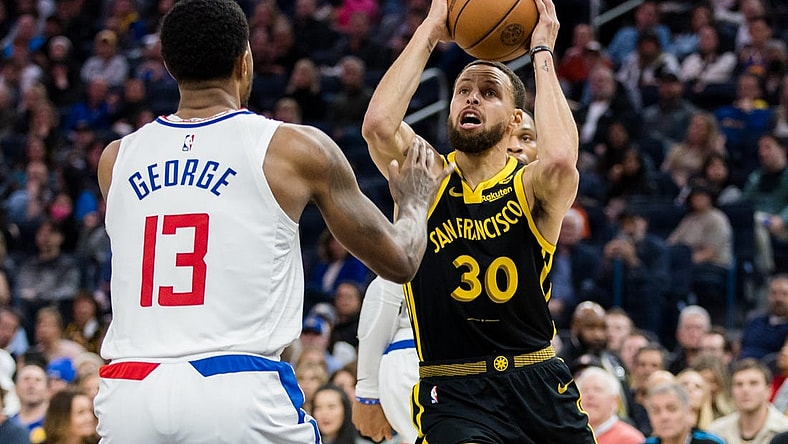 Feb 14, 2024; San Francisco, California, USA; Golden State Warriors guard Stephen Curry (30) passes over LA Clippers forward Paul George (13) during the first half at Chase Center. Mandatory Credit: John Hefti-USA TODAY Sports