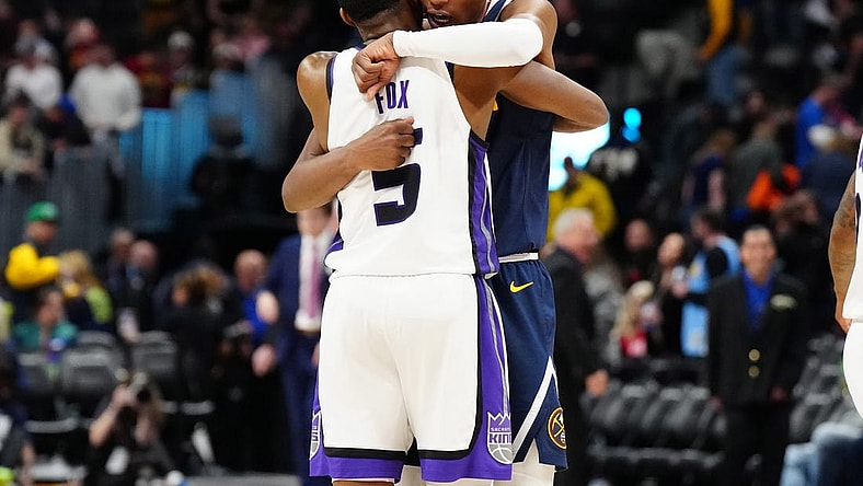 Feb 14, 2024; Denver, Colorado, USA; Sacramento Kings guard De'Aaron Fox (5) and Denver Nuggets forward Peyton Watson (8) following the game at Ball Arena. Mandatory Credit: Ron Chenoy-USA TODAY Sports