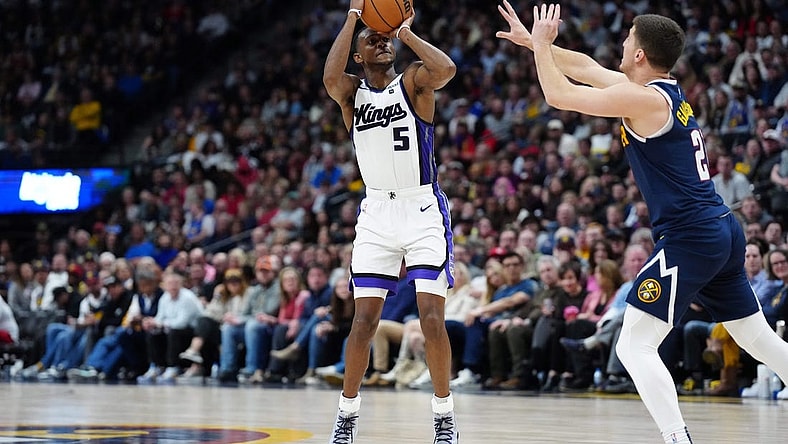 Feb 14, 2024; Denver, Colorado, USA; Sacramento Kings guard De'Aaron Fox (5) shoots the ball over Denver Nuggets guard Collin Gillespie (21) in the second half at Ball Arena. Mandatory Credit: Ron Chenoy-USA TODAY Sports