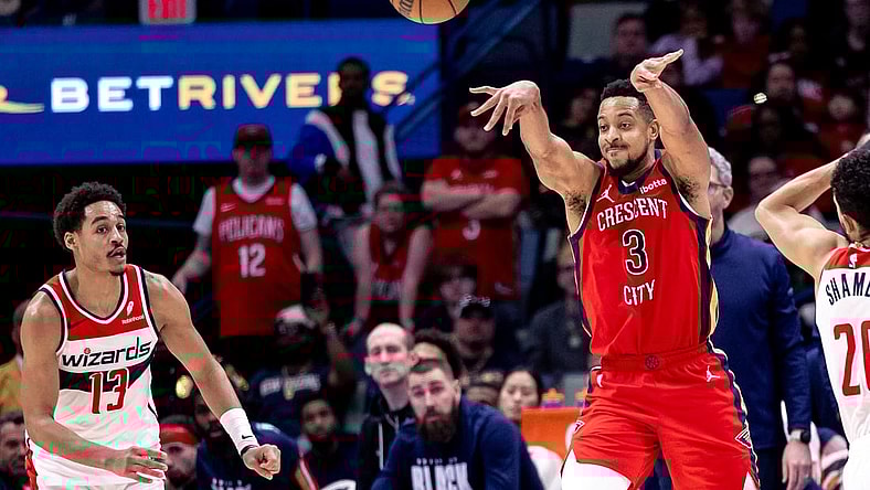 Feb 14, 2024; New Orleans, Louisiana, USA;  New Orleans Pelicans guard CJ McCollum (3) passes the ball against Washington Wizards guard Jordan Poole (13) during the second half at Smoothie King Center. Mandatory Credit: Stephen Lew-USA TODAY Sports