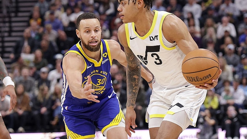 Feb 15, 2024; Salt Lake City, Utah, USA; Utah Jazz guard Keyonte George (3) keeps the ball away from Golden State Warriors guard Stephen Curry (30) during the first quarter at Delta Center. Mandatory Credit: Chris Nicoll-USA TODAY Sports