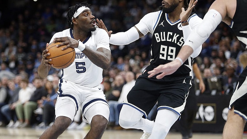 Feb 15, 2024; Memphis, Tennessee, USA; Memphis Grizzlies guard Vince Williams Jr. (5) handles the ball as Milwaukee Bucks forward Jae Crowder (99) defends during the first half at FedExForum. Mandatory Credit: Petre Thomas-USA TODAY Sports