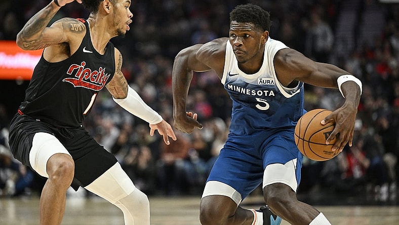 Feb 15, 2024; Portland, Oregon, USA; Minnesota Timberwolves guard Anthony Edwards (5) drives to the basket during the first half against Portland Trail Blazers guard Anfernee Simons (1) at Moda Center. Mandatory Credit: Troy Wayrynen-USA TODAY Sports