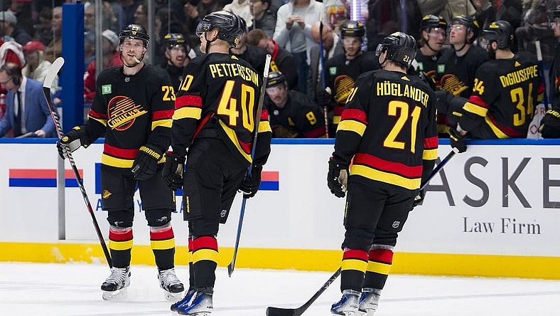 Feb 15, 2024; Vancouver, British Columbia, CAN; Vancouver Canucks forward Nils Hoglander (21) and forward Elias Pettersson (40) and celebrate Lindholm s second goal of the game against the Detroit Red Wings in the third period at Rogers Arena. Vancouver won 4-1. Mandatory Credit: Bob Frid-USA TODAY Sports