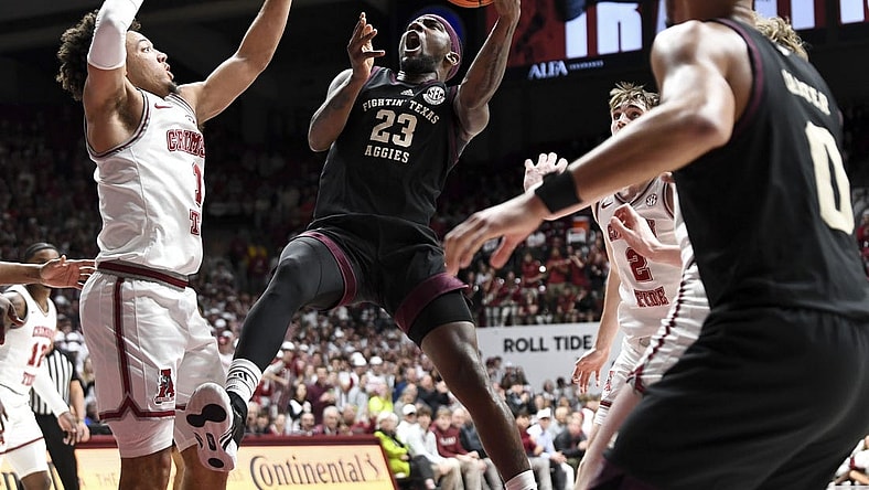 Feb 17, 2024; Tuscaloosa, Alabama, USA; Texas A&M Aggies guard Tyrece Radford (23) shoots in the lane against Alabama Crimson Tide guard Mark Sears (1) during the first half at Coleman Coliseum. Mandatory Credit: Gary Cosby Jr.-USA TODAY Sports