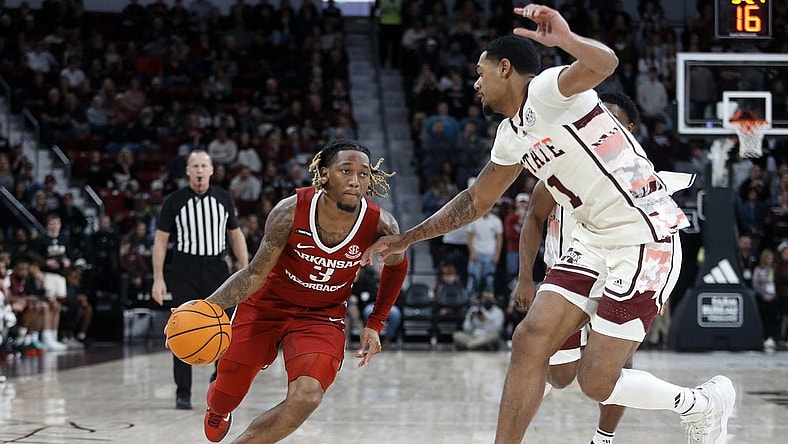 Feb 17, 2024; Starkville, Mississippi, USA; Arkansas Razorbacks guard El Ellis (3) drives to the basket against Mississippi State Bulldogs forward Tolu Smith (1) during the second half at Humphrey Coliseum. Mandatory Credit: Petre Thomas-USA TODAY Sports