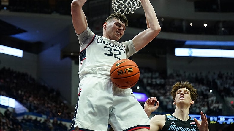 Feb 17, 2024; Hartford, Connecticut, USA; UConn Huskies center Donovan Clingan (32) makes the basket against the Marquette Golden Eagles in the second half at XL Center. Mandatory Credit: David Butler II-USA TODAY Sports
