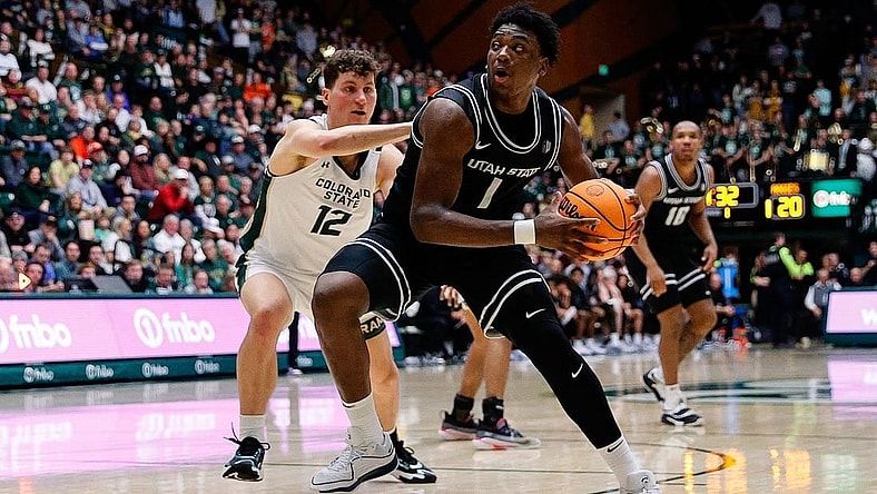 Feb 17, 2024; Fort Collins, Colorado, USA; Utah State Aggies forward Great Osobor (1) controls the ball against Colorado State Rams forward Patrick Cartier (12) in the first half at Moby Arena. Mandatory Credit: Isaiah J. Downing-USA TODAY Sports