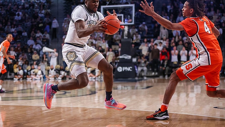Feb 17, 2024; Atlanta, Georgia, USA; Georgia Tech Yellow Jackets forward Ibrahima Sacko (23) grabs the ball from Syracuse Orange forward Chris Bell (4) in the first half at McCamish Pavilion. Mandatory Credit: Brett Davis-USA TODAY Sports