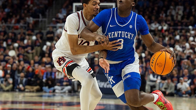 Kentucky Wildcats guard Adou Thiero (3) drives the ball on Auburn Tigers forward Chad Baker-Mazara (10) as Auburn Tigers take on Kentucky Wildcats at Neville Arena in Auburn, Ala., on Saturday, Feb. 17, 2024.