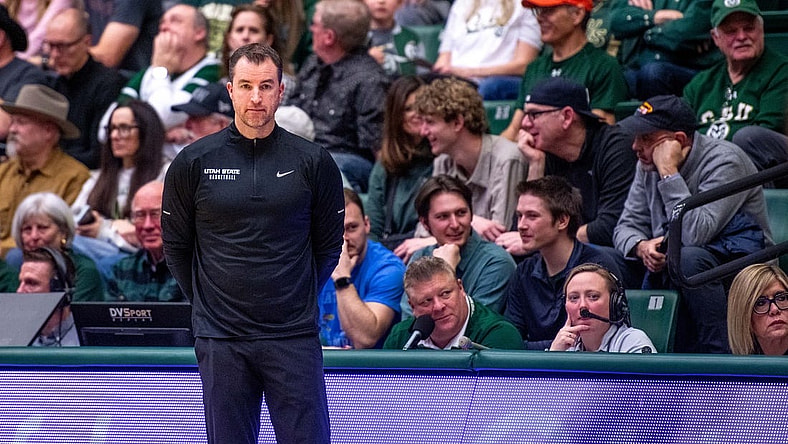 Utah State basketball head coach Danny Sprinkle stares off into the distance after a turnover in a blowout loss against Colorado State at Moby Arena on Saturday, Feb. 17, 2024 in Fort Collins, Colo.