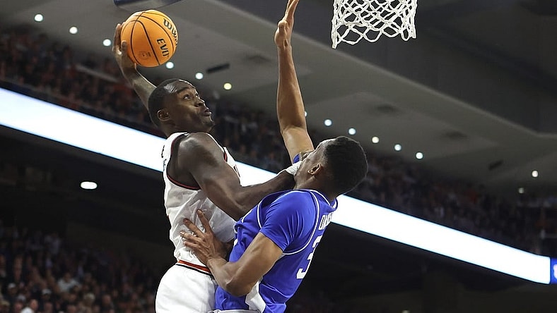 Feb 17, 2024; Auburn, Alabama, USA; Auburn Tigers forward Jaylin Williams (2) goes up against Kentucky Wildcats forward Ugonna Onyenso (33) for a shot during the second half at Neville Arena. Mandatory Credit: John Reed-USA TODAY Sports