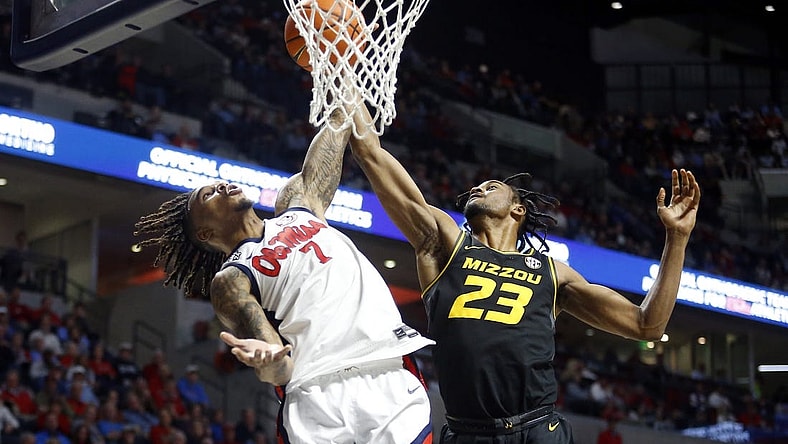 Feb 17, 2024; Oxford, Mississippi, USA; Mississippi Rebels guard Allen Flanigan (7) and Missouri Tigers forward Aidan Shaw (23) battle for a rebound during the first half at The Sandy and John Black Pavilion at Ole Miss. Mandatory Credit: Petre Thomas-USA TODAY Sports
