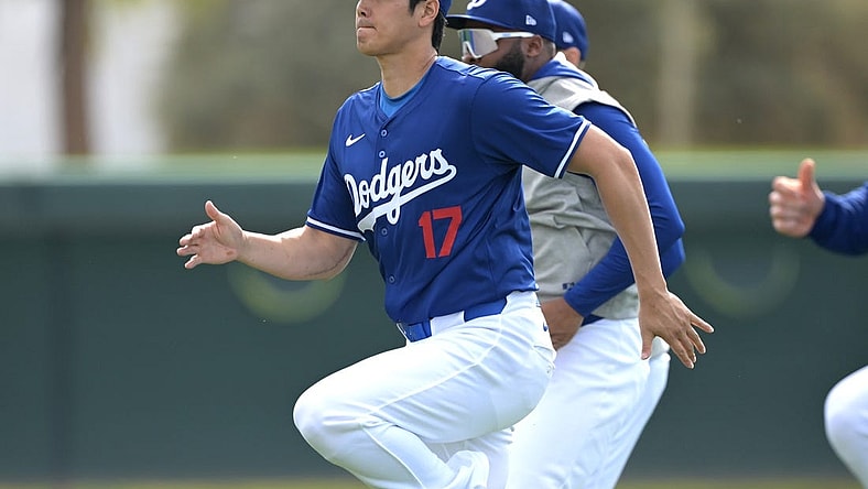 Feb 18, 2024; Glendale, AZ, USA;  Los Angeles Dodgers designated hitter Shohei Ohtani (17) stretches during spring training at Camelback Ranch. Mandatory Credit: Jayne Kamin-Oncea-USA TODAY Sports