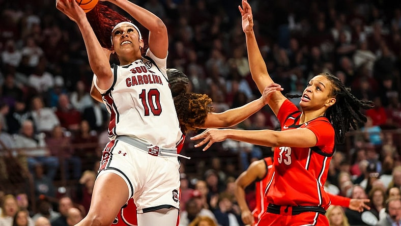 Feb 18, 2024; Columbia, South Carolina, USA; South Carolina Gamecocks center Kamilla Cardoso (10) shoots over Georgia Lady Bulldogs forward Destiny Thomas (33) in the first half at Colonial Life Arena. Mandatory Credit: Jeff Blake-USA TODAY Sports