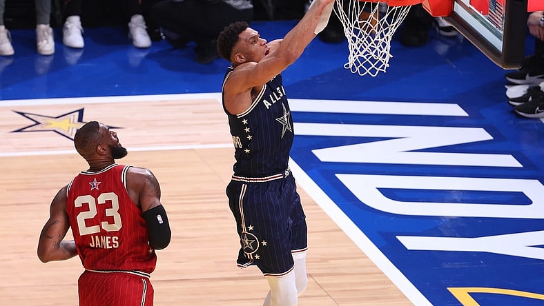 Feb 18, 2024; Indianapolis, Indiana, USA; Eastern Conference forward Giannis Antetokounmpo (34) of the Milwaukee Bucks dunks the ball past Western Conference forward LeBron James (23) of the Los Angeles Lakers during the first quarter in the 73rd NBA All Star game at Gainbridge Fieldhouse. Mandatory Credit: Trevor Ruszkowski-USA TODAY Sports