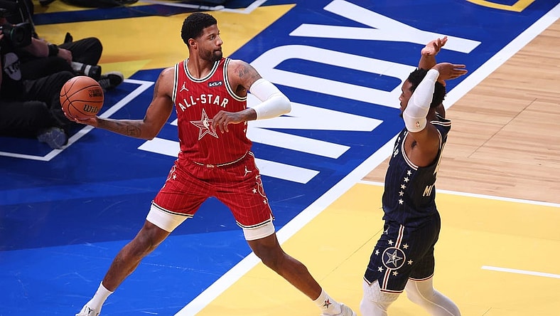 Feb 18, 2024; Indianapolis, Indiana, USA; Western Conference forward Paul George (13) of the LA Clippers attempts to save the ball against Eastern Conference guard Donovan Mitchell (45) of the Cleveland Cavaliers during the third quarter in the 73rd NBA All Star game at Gainbridge Fieldhouse. Mandatory Credit: Trevor Ruszkowski-USA TODAY Sports
