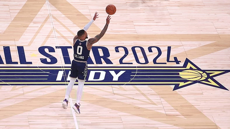 Feb 18, 2024; Indianapolis, Indiana, USA; Eastern Conference guard Damian Lillard (0) of the Milwaukee Bucks makes a three point basket from half court against the Western Conference All-Stars during the fourth quarter in the 73rd NBA All Star game at Gainbridge Fieldhouse. Mandatory Credit: Trevor Ruszkowski-USA TODAY Sports