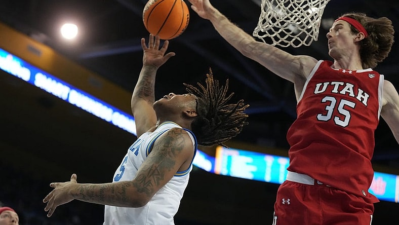 Feb 18, 2024; Los Angeles, California, USA; UCLA Bruins guard Brandon Williams (5) shoots the ball against Utah Utes center Branden Carlson (35) in the second half at Pauley Pavilion presented by Wescom. Utah defeated UCLA 70-69. Mandatory Credit: Kirby Lee-USA TODAY Sports