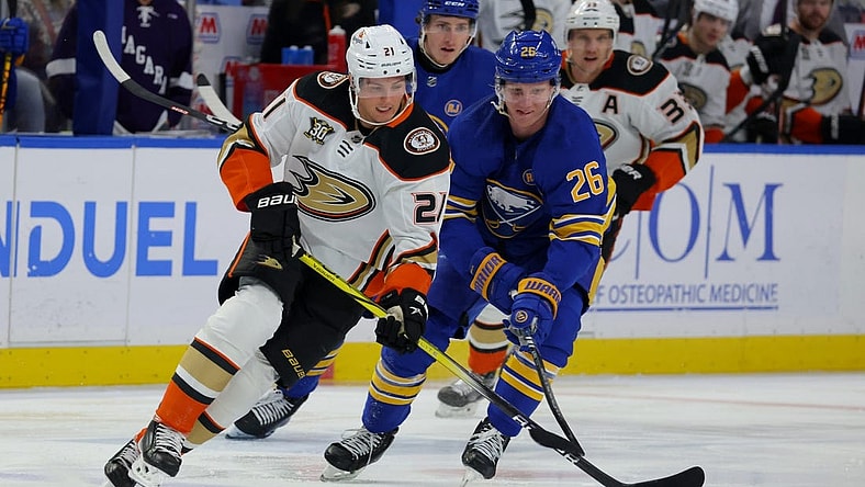 Feb 19, 2024; Buffalo, New York, USA;  Anaheim Ducks center Isac Lundestrom (21) looks to control the puck as Buffalo Sabres defenseman Rasmus Dahlin (26) defends during the first period at KeyBank Center. Mandatory Credit: Timothy T. Ludwig-USA TODAY Sports