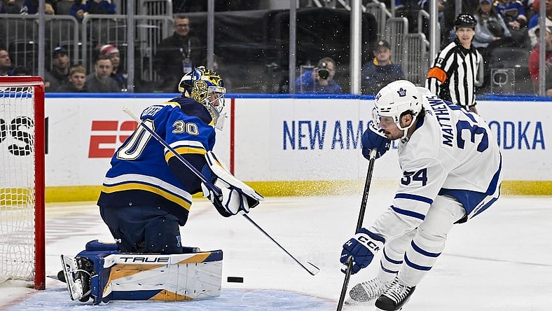 Feb 19, 2024; St. Louis, Missouri, USA;  Toronto Maple Leafs center Auston Matthews (34) shoots against St. Louis Blues goaltender Joel Hofer (30) during the first period at Enterprise Center. Mandatory Credit: Jeff Curry-USA TODAY Sports