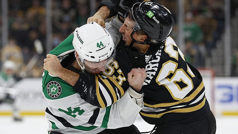 Feb 19, 2024; Boston, Massachusetts, USA; Dallas Stars defenseman Joel Hanley (44) fights with Boston Bruins left wing Brad Marchand (63) during the first period at TD Garden. Mandatory Credit: Winslow Townson-USA TODAY Sports