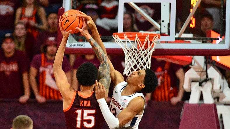 Feb 19, 2024; Blacksburg, Virginia, USA; Virginia Cavaliers guard Ryan Dunn (13) goes up to defend a dunk by Virginia Tech Hokies center Lynn Kidd (15) during the first half at Cassell Coliseum. Mandatory Credit: Brian Bishop-USA TODAY Sports