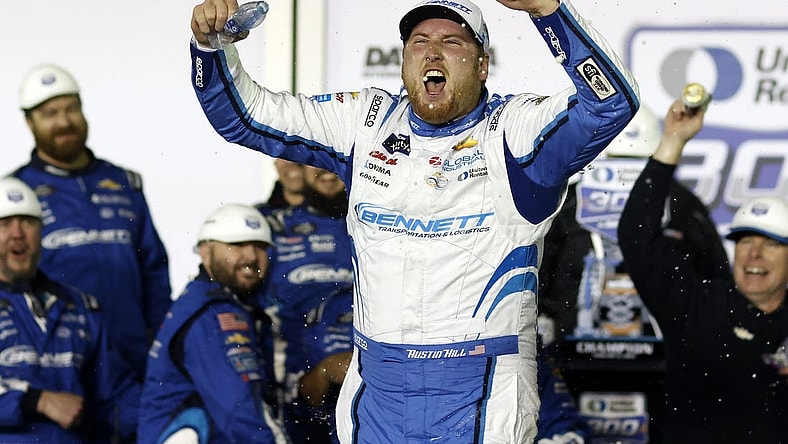 Feb 19, 2024; Daytona Beach, Florida, USA; Xfinity Series driver Austin Hill (21) reacts in victory lane after winning the United Rentals 300 at Daytona International Speedway. Mandatory Credit: Peter Casey-USA TODAY Sports