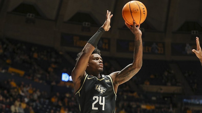 Feb 20, 2024; Morgantown, West Virginia, USA; UCF Knights guard Jaylin Sellers (24) shoots a three pointer during the first half against the West Virginia Mountaineers at WVU Coliseum. Mandatory Credit: Ben Queen-USA TODAY Sports