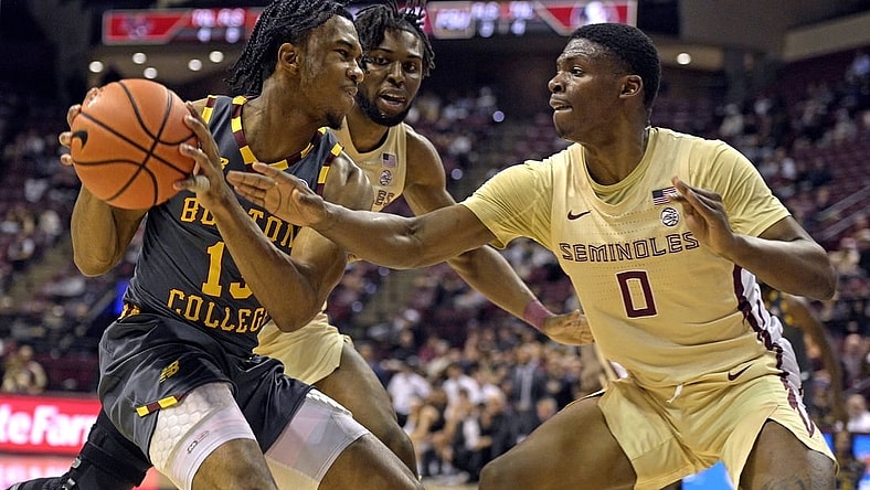 Feb 20, 2024; Tallahassee, Florida, USA; Boston College Eagles guard Donald Hand Jr. (13) is pressured by Florida State Seminoles guard Chandler Jackson (0) during the first half at Donald L. Tucker Center. Mandatory Credit: Melina Myers-USA TODAY Sports
