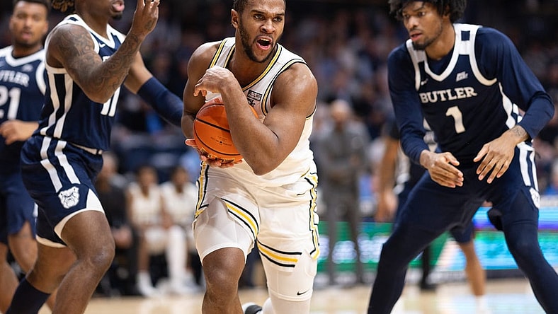 Feb 20, 2024; Villanova, Pennsylvania, USA; Villanova Wildcats forward Eric Dixon (43) controls the ball against Butler Bulldogs guard Jahmyl Telfort (11) and forward Jalen Thomas (1) during the second half at William B. Finneran Pavilion. Mandatory Credit: Bill Streicher-USA TODAY Sports