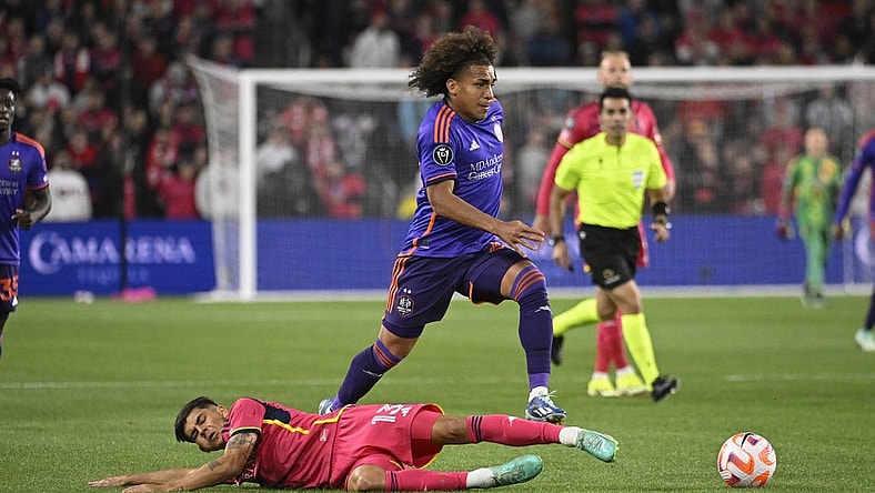 Feb 20, 2024; St. Louis, MO, USA; Houston Dynamo midfielder Adalberto Carrasquilla (20) dribbles past St. Louis City defender Anthony Markanich (13) during the first half of the CONCACAF Champions Cup-Round One at CITYPARK. Mandatory Credit: Joe Puetz-USA TODAY Sports