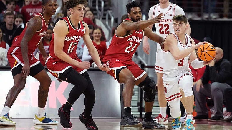 Feb 20, 2024; Madison, Wisconsin, USA;  Wisconsin Badgers guard Connor Essegian (3) passes the ball against Maryland Terrapins forward Donta Scott (24) and Maryland Terrapins forward Jamie Kaiser Jr. (12) during the first half at the Kohl Center. Mandatory Credit: Kayla Wolf-USA TODAY Sports