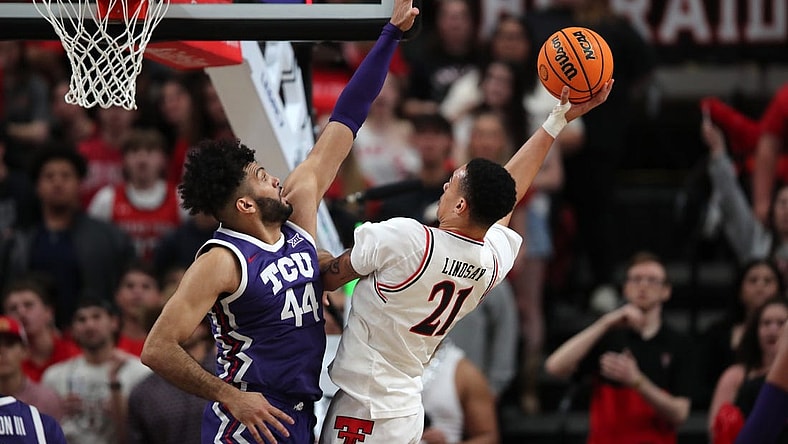 Feb 20, 2024; Lubbock, Texas, USA;  Texas Tech Red Raiders forward KyeRon Lindsey (21) shoots against TCU Horned Frogs forward Essam Mostafa (44) in the first half at United Supermarkets Arena. Mandatory Credit: Michael C. Johnson-USA TODAY Sports