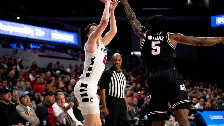 Cincinnati Bearcats guard Simas Lukosius (41) hits a basket over Oklahoma State Cowboys guard Quion Williams (5) in the first half of the NCAA basketball game between Cincinnati Bearcats and Oklahoma State Cowboys at Fifth Third Arena in Cincinnati on Wednesday, Feb. 21, 2024.