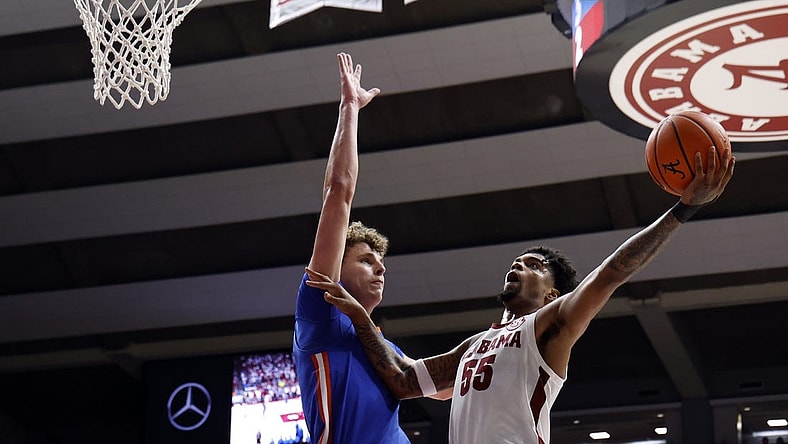 Feb 21, 2024; Tuscaloosa, Alabama, USA; Alabama Crimson Tide guard Aaron Estrada (55) shoots as Florida Gators center Micah Handlogten (3) defends during the first half at Coleman Coliseum. Mandatory Credit: Butch Dill-USA TODAY Sports