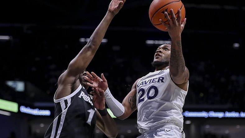 Feb 21, 2024; Cincinnati, Ohio, USA; Xavier Musketeers guard Dayvion McKnight (20) shoots against Providence Friars guard Jayden Pierre (1) in the first half at Cintas Center. Mandatory Credit: Katie Stratman-USA TODAY Sports
