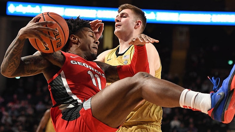 Feb 21, 2024; Nashville, Tennessee, USA; Georgia Bulldogs guard Justin Hill (11) grabs a rebound against Vanderbilt Commodores forward Carter Lang (35) during the first half at Memorial Gymnasium. Mandatory Credit: Christopher Hanewinckel-USA TODAY Sports