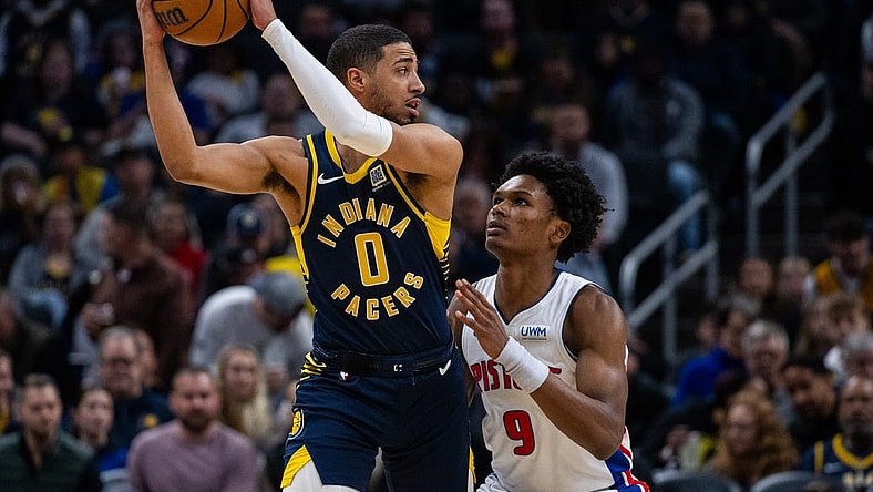 Feb 22, 2024; Indianapolis, Indiana, USA; Indiana Pacers guard Tyrese Haliburton (0) holds the ball while Detroit Pistons forward Ausar Thompson (9) defends in the first half at Gainbridge Fieldhouse. Mandatory Credit: Trevor Ruszkowski-USA TODAY Sports