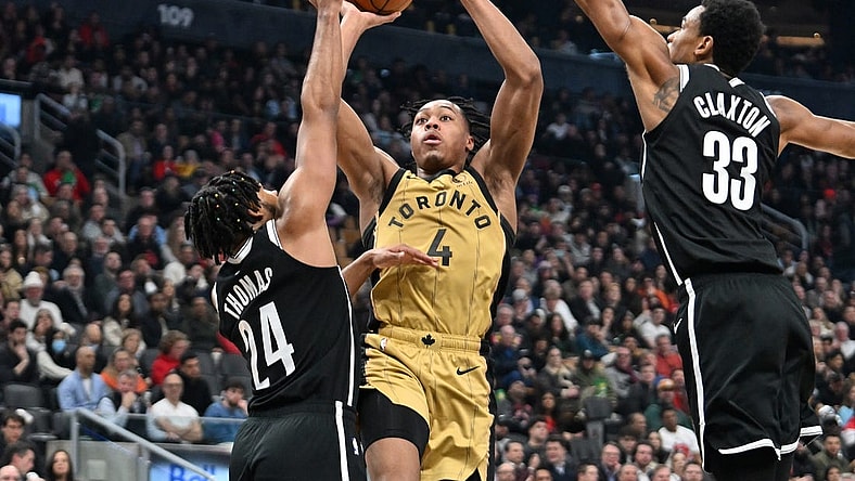 Feb 22, 2024; Toronto, Ontario, CAN;   Toronto Raptors forward Scottie Barnes (4) shoots the ball as Brooklyn Nets guard Cam Thomas (24) and center Nic Claxton (33) defend in the first half at Scotiabank Arena. Mandatory Credit: Dan Hamilton-USA TODAY Sports