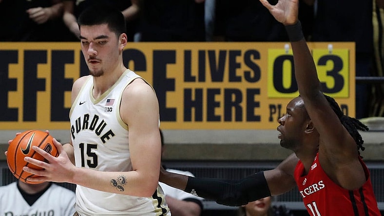 Purdue Boilermakers center Zach Edey (15) is defended by Rutgers Scarlet Knights center Clifford Omoruyi (11) during the NCAA men s basketball game, Thursday, Feb. 22, 2024, at Mackey Arena in West Lafayette, Ind.