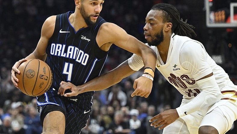 Feb 22, 2024; Cleveland, Ohio, USA; Orlando Magic guard Jalen Suggs (4) dribbles beside Cleveland Cavaliers guard Darius Garland (10) in the second quarter at Rocket Mortgage FieldHouse. Mandatory Credit: David Richard-USA TODAY Sports