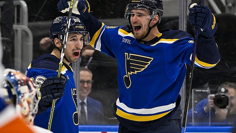 Feb 22, 2024; St. Louis, Missouri, USA;  St. Louis Blues left wing Pavel Buchnevich (89) celebrates with center Jordan Kyrou (25) after scoring his second goal of the game against New York Islanders goaltender Semyon Varlamov (40) during the second period at Enterprise Center. Mandatory Credit: Jeff Curry-USA TODAY Sports