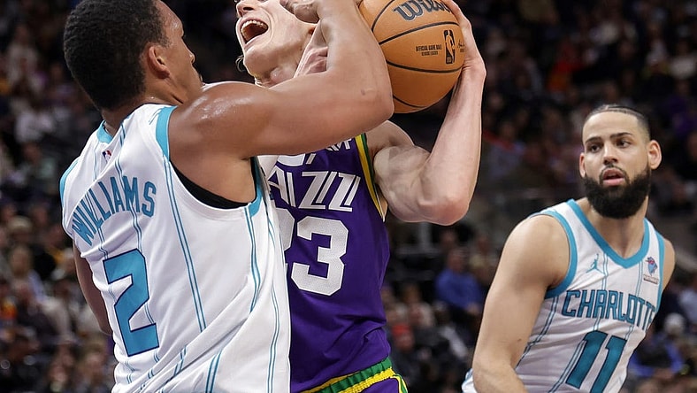 Feb 22, 2024; Salt Lake City, Utah, USA;  Utah Jazz forward Lauri Markkanen (23) is fouled by Charlotte Hornets forward Grant Williams (2) during the second quarter at Delta Center. Mandatory Credit: Chris Nicoll-USA TODAY Sports