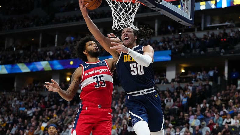 Feb 22, 2024; Denver, Colorado, USA; Denver Nuggets forward Aaron Gordon (50) shoots past Washington Wizards forward Marvin Bagley III (35) in the second quarter at Ball Arena. Mandatory Credit: Ron Chenoy-USA TODAY Sports